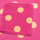 Pink twisted ribbed top with orange polka dots and a patch pocket.