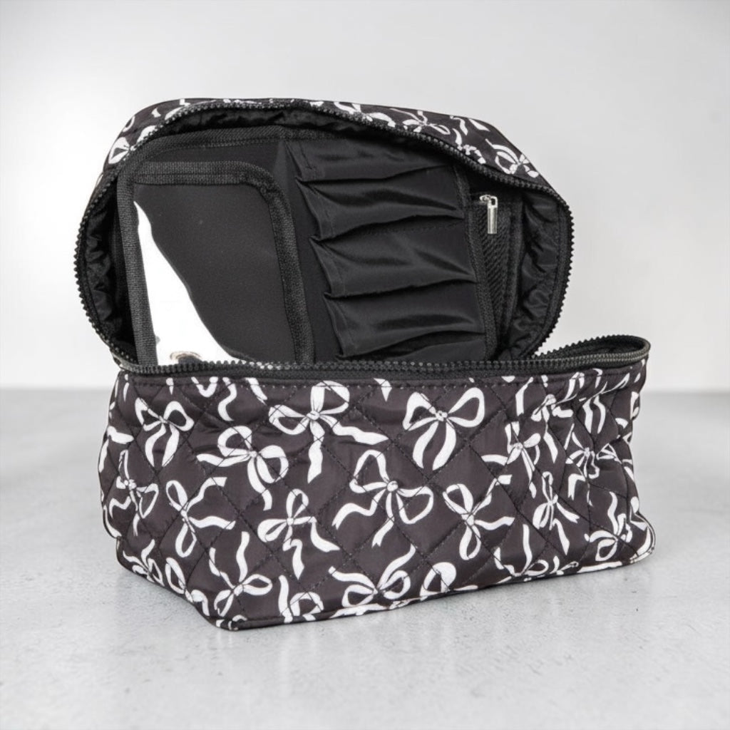 Black and white coquette bows quilted cosmetic bag with bow motif and organized interior compartments