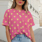 Pink polka dot patch pocket twisted ribbed top with yellow dots, worn by a woman.