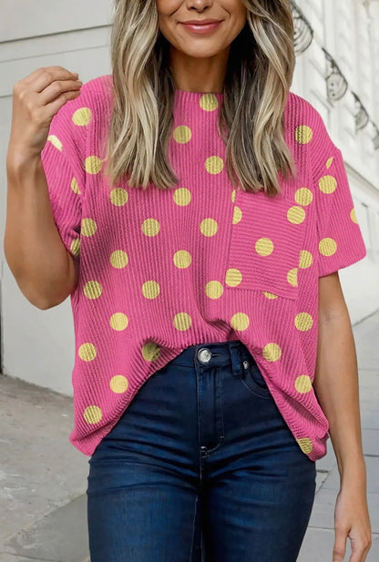 Pink polka dot twisted ribbed top with a patch pocket and short sleeves.