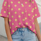 Pink twisted ribbed knit top with short sleeves, yellow polka dots, and a front patch pocket.