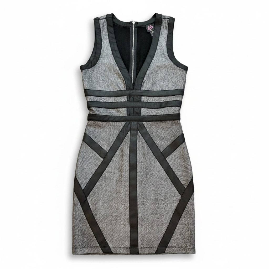 B2 Bebe black sleeveless cocktail dress with silver shimmer contrast and geometric satin panels, knee-length.