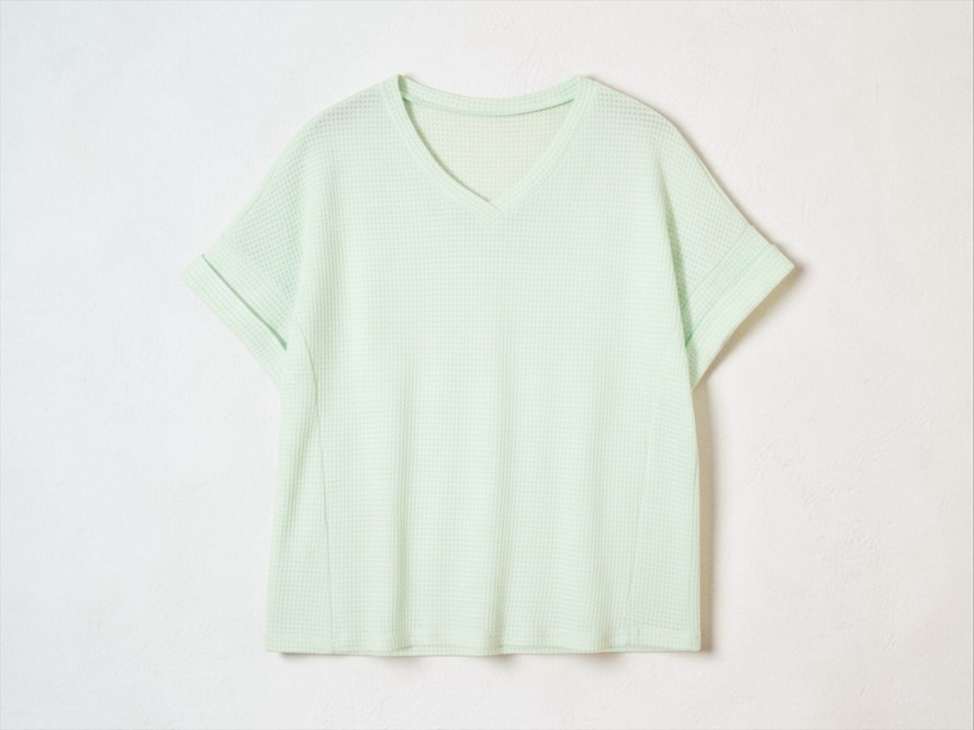 LemonDrop•LimePop mint green waffle knit short sleeve V-neck top with cuffed sleeves.