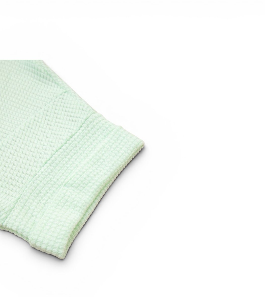 LemonDrop•LimePop mint green waffle knit short sleeve top with V-neck and cuffed sleeves.