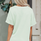 LemonDrop•LimePop mint green waffle knit short sleeve V-neck top with cuffed sleeves.