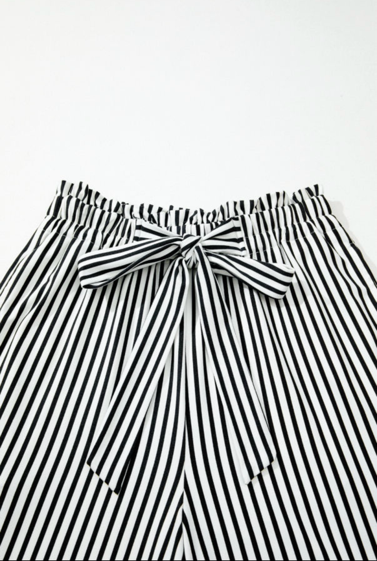 LemonDrop•LimePop black and white striped wide-leg palazzo pants with tie waist and elasticated waistband.